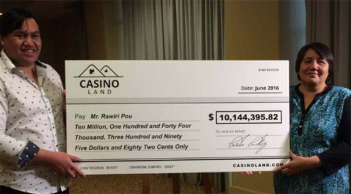 Maori guy with cheque of winning